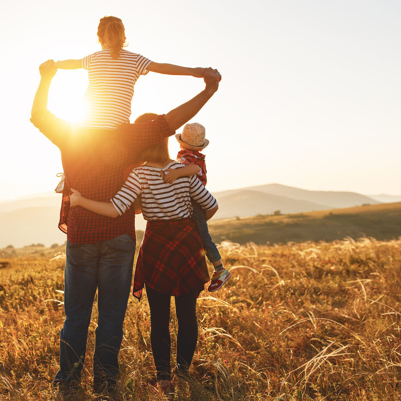 Happy family: mother, father, children son and  daughter on nature  on sunset